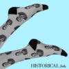 Ronald Reagan socks in gray shown from the side, worn with legs raised