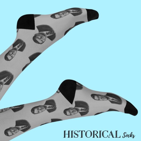 Ronald Reagan socks in gray shown from the side, worn with legs raised