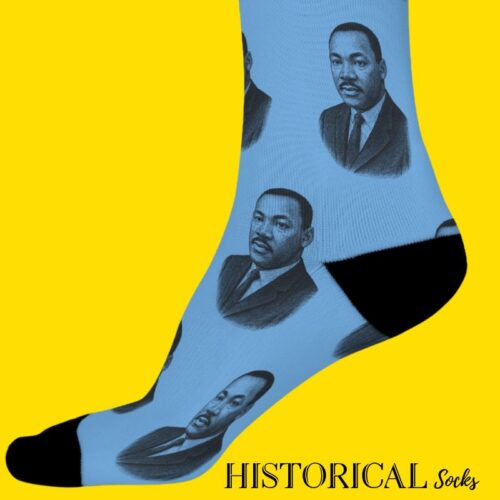 Side view of Martin Luther King Jr. socks in blue with black accents, worn on standing legs