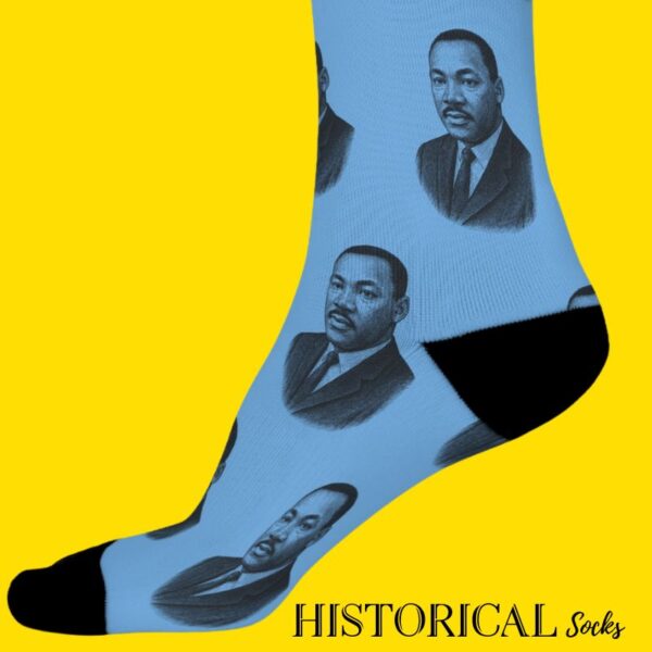 Side view of Martin Luther King Jr. socks in blue with black accents, worn on standing legs