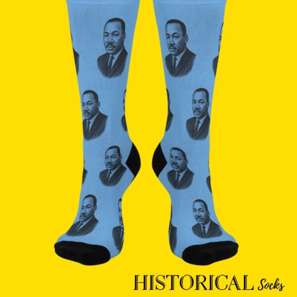 Front-facing view of MLK portrait socks in blue worn by standing model
