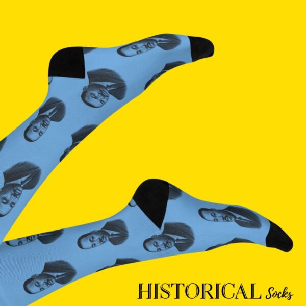 Martin Luther King socks in blue worn with legs raised on light background