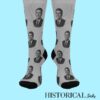 Gray socks featuring Ronald Reagan's portrait, worn on standing feet