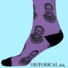 ide view of purple socks featuring Ernest Hemingway illustration, worn on feet