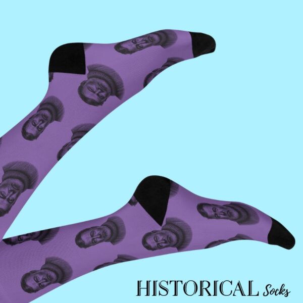 Purple Ernest Hemingway socks with black heels and toes, worn on raised legs