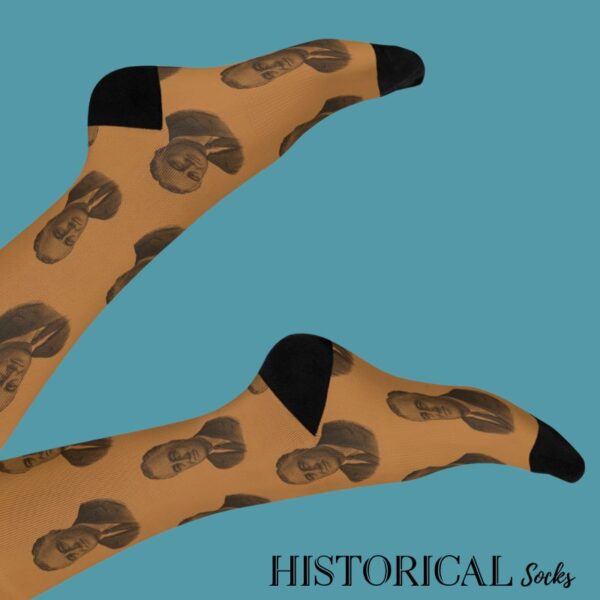 Franklin D. Roosevelt socks worn on crossed legs – brown with black detailing and vintage-style print