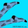 Artistic shot of Jesus Socks Blue with legs up against a light blue background