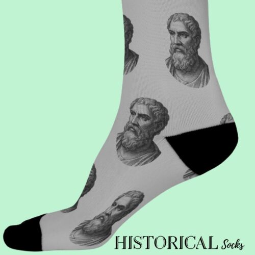 Side view of gray Epictetus socks with black heel and toe accents, worn on feet