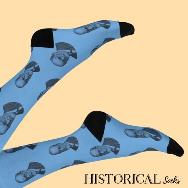 Blue Sigmund Freud socks with black detailing worn on raised legs