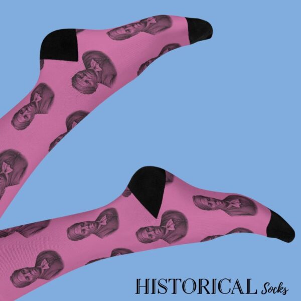 Pink Harriet Tubman socks worn on raised legs