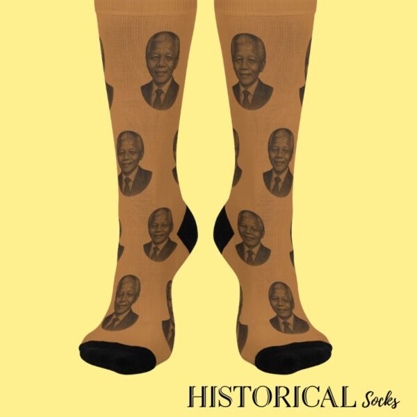 Front-facing view of brown socks featuring Nelson Mandela portrait pattern with black accents